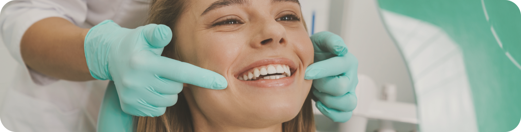 Cosmetic Dentistry example picture - woman smiling with a dentist using fingers to show the smile with green rubber gloves